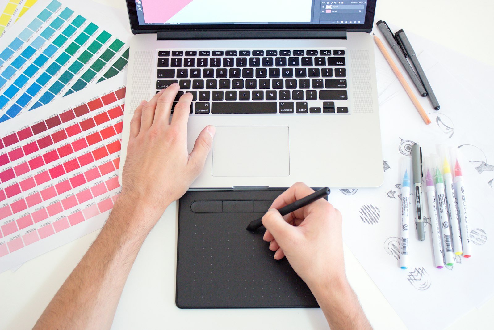 Designer using a drawing tablet with colour swatches