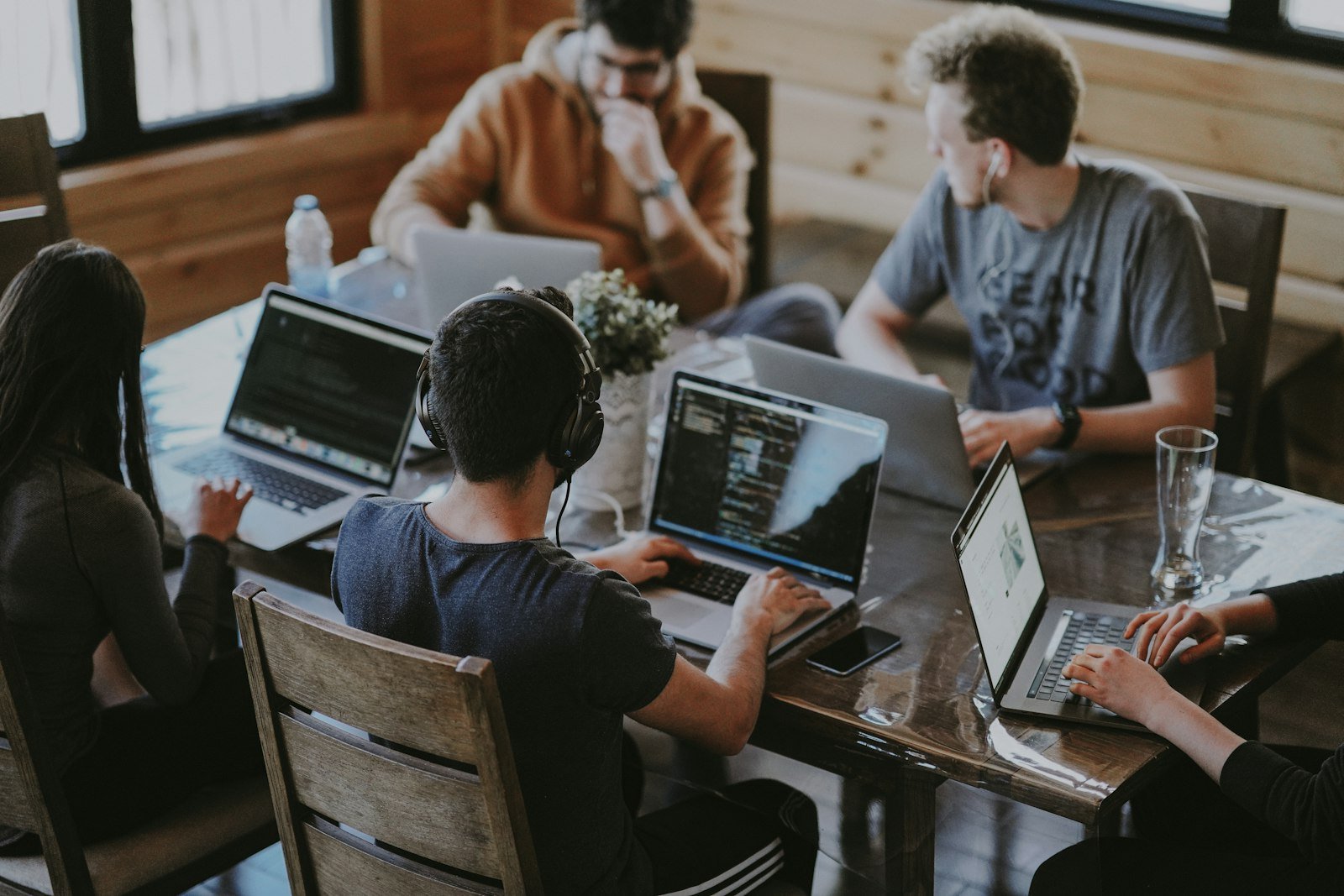 Marketing team working together around laptops