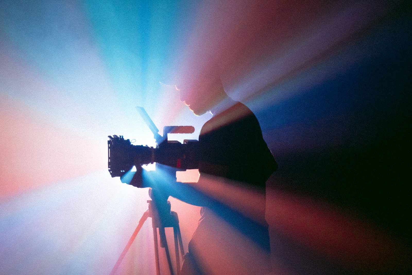 Person filming with a camera on a tripod