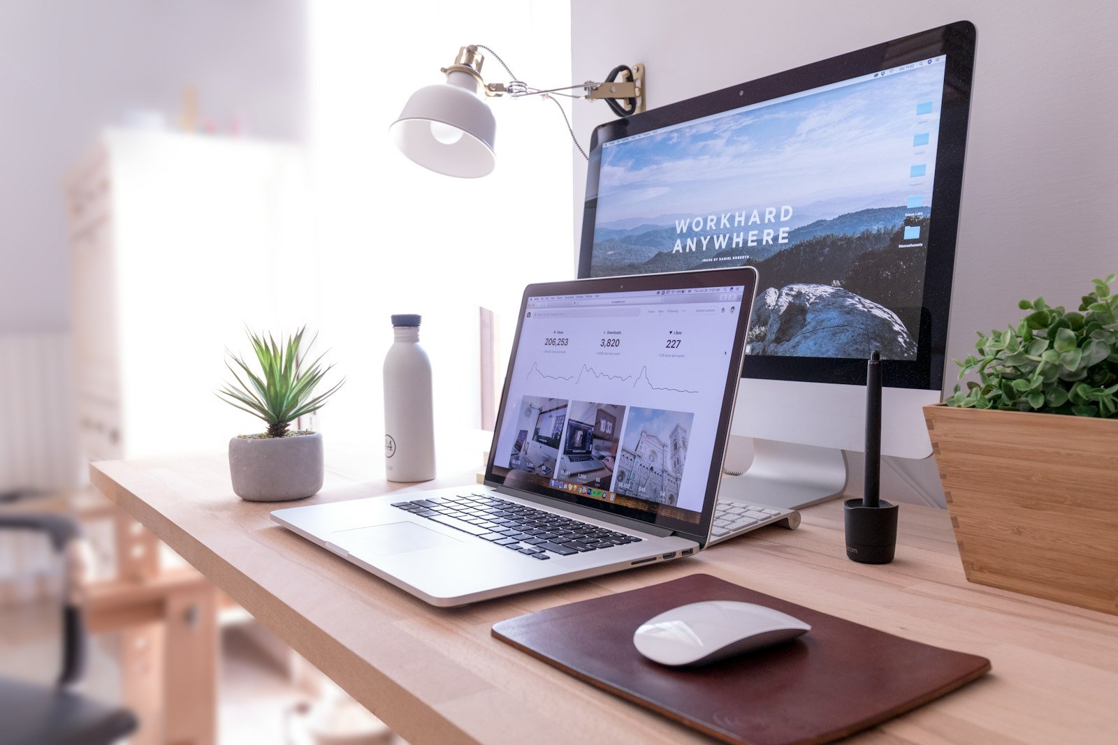 Designer workspace with MacBook and iMac